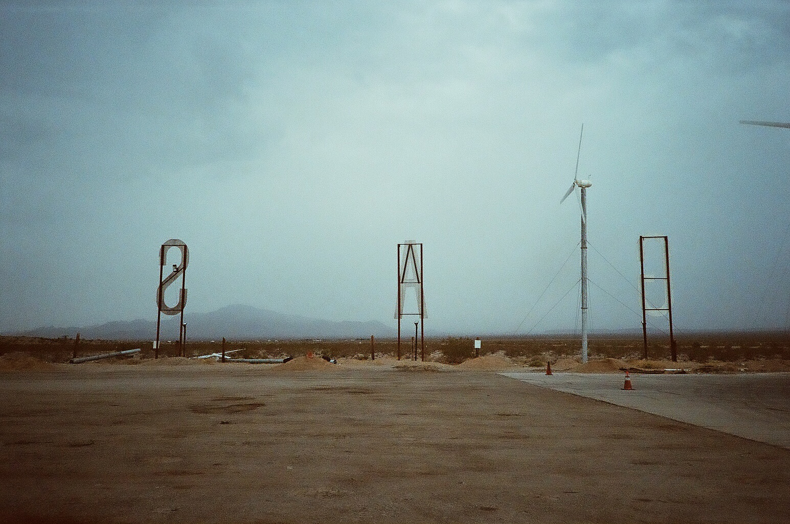 back of three large letter signs that make up the word gas