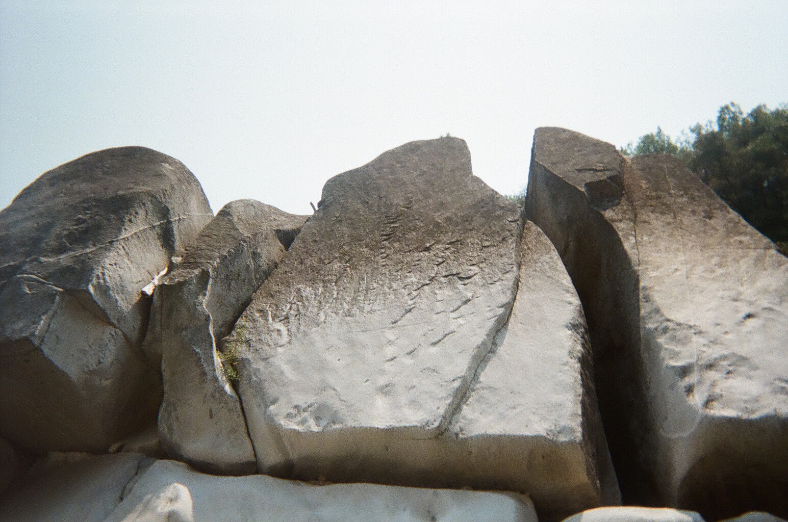 large smooth river boulders against blue sky