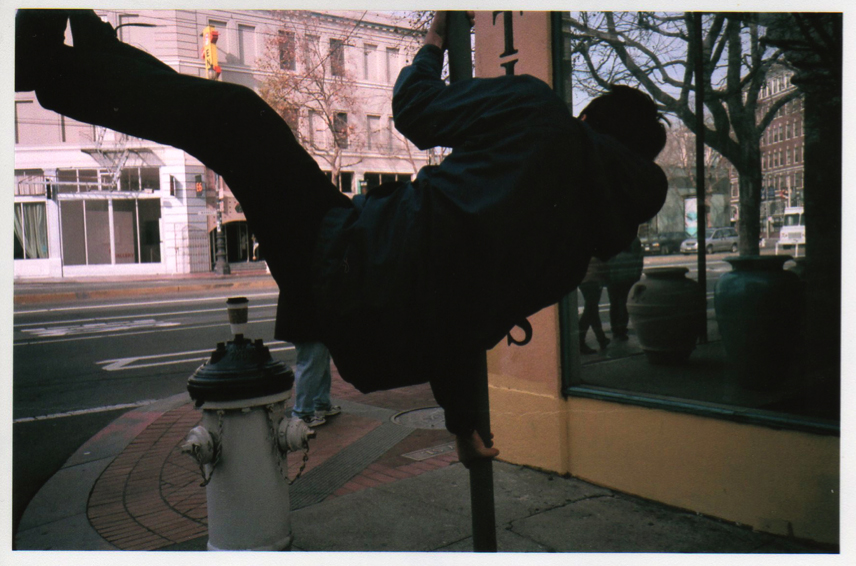 person climbing street sign